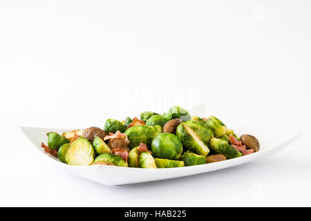 Brussels sprouts with chestnuts and bacon isolated on white background Stock Photo