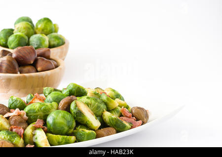 Brussels sprouts with chestnuts and bacon isolated on white background Stock Photo