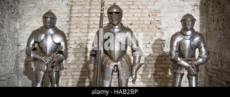 medieval armor knight steel metal horizontal brick wall brown Stock Photo