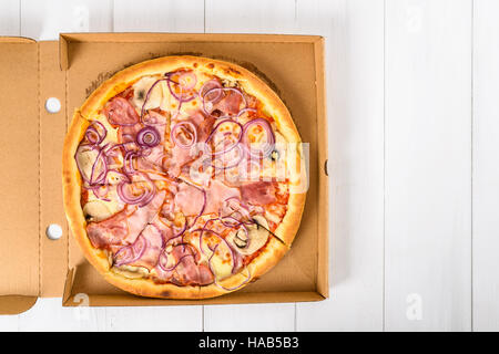 Italian Pizza With Bacon Ham, Mozzarella Cheese, Onion And Mushrooms Stock Photo