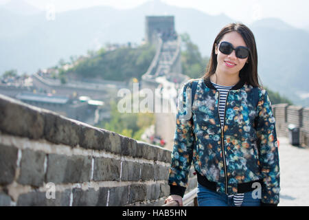 Happy tourist climbing the Great Wall of China Stock Photo