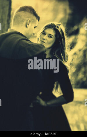young couple standing in a middle of the street Stock Photo