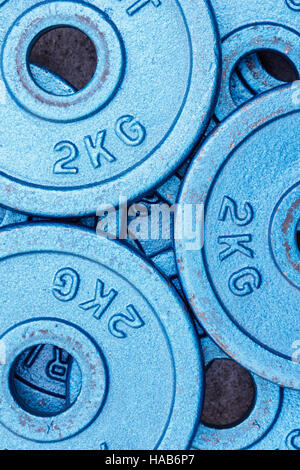 Blue weight plates of 2 kilograms stacked in an alternating pattern. Stock Photo