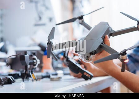 Close up of mans hands holding drone propeller Stock Photo