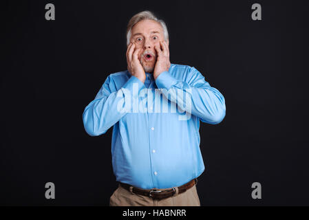Shocked man with wide opened eyes and mouth Stock Photo