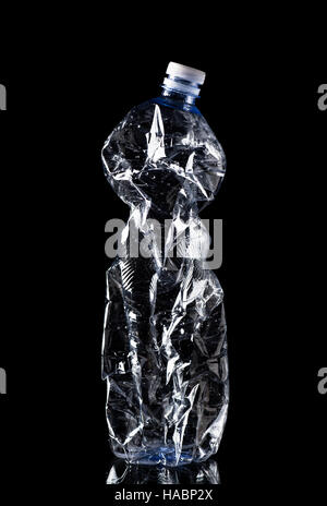 Crumpled Plastic Bottle Isolated on Black Background Stock Photo