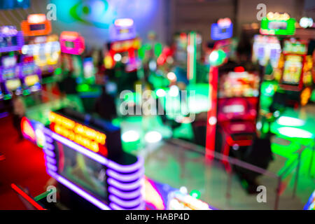 Blurry image of slots machines and other gambling equipment at a casino. Out of focus (bokeh) colourful and high contrast picture in a casino. Stock Photo