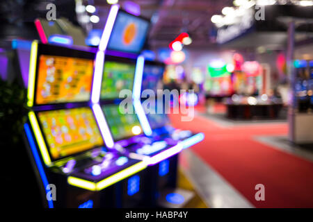 Blurry image of slots machines and other gambling equipment at a casino. Out of focus (bokeh) colourful and high contrast picture in a casino. Stock Photo