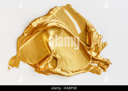 Gold acrylic paint on white background Stock Photo
