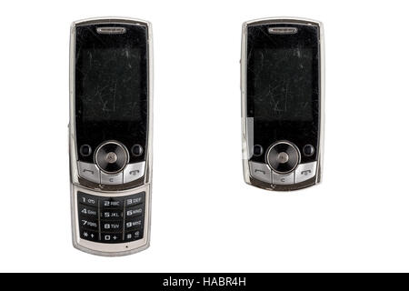 very old scratched mobile phone, isolated on white Stock Photo