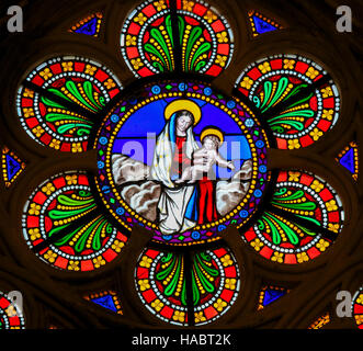 Stained Glass window in the Cathedral of Bayeux, France, depicting Mother Mary and the Child Jesus Stock Photo