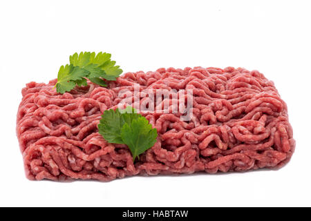 uncooked  minced meat with garnish on a white isolated background Stock Photo