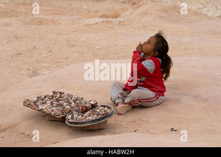 Jordanian Bedouin girl sells souvenirs in Petra, Jordan Stock Photo