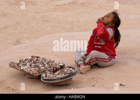 Jordanian Bedouin girl sells souvenirs in Petra, Jordan Stock Photo