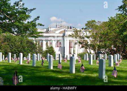 Gravestones with American flags near Memorial Amphitheater at Arlington National Cemetery Arlington, Virginia, USA. Stock Photo