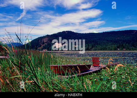 Powell River, BC, British Columbia, Canada - Canoe and Armchair on Dock at Cranberry Lake on Sunshine Coast Stock Photo