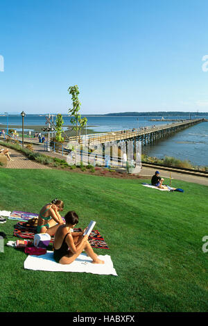White Rock city pier in the dusk with flying Flag of Canada, British