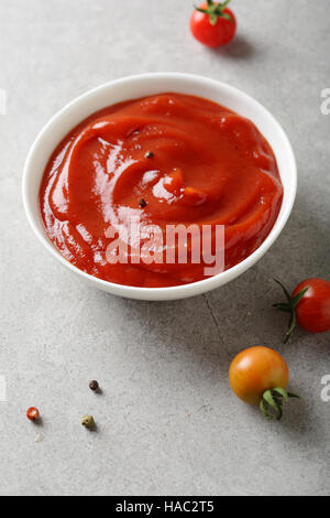 tomato sauce in white bowl, food closeup Stock Photo