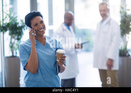 Female doctor talking on mobile phone Stock Photo