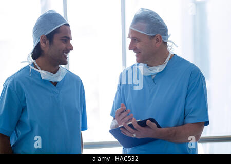 Surgeons discussing over medical reports Stock Photo