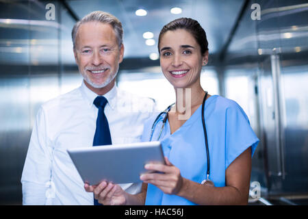 Doctor and colleague discussing over digital tablet Stock Photo