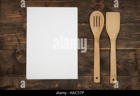 Wooden kitchenware and blank paper sheets for recipes on wood  board Stock Photo