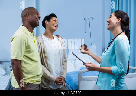 Doctor interacting with patient parents Stock Photo