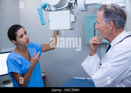 Nurse interacting with doctor in x-ray room Stock Photo
