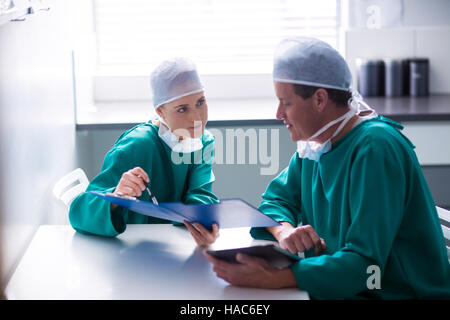 Surgeons having discussion on file Stock Photo
