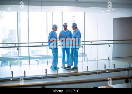 Team of surgeons discussing over digital tablet Stock Photo