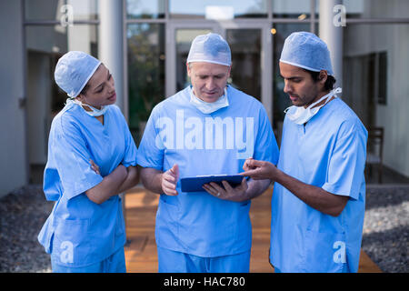 Team of surgeons discussing over medical reports Stock Photo