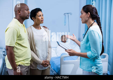 Doctor interacting with patient parents Stock Photo