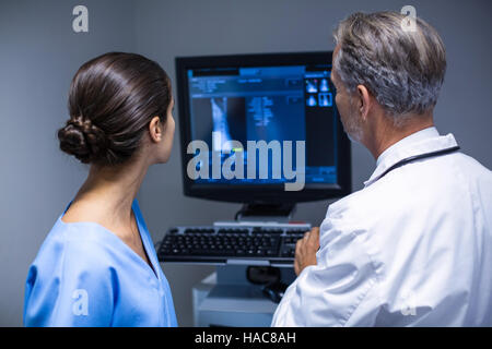 Doctor and nurse examining x-ray on computer Stock Photo