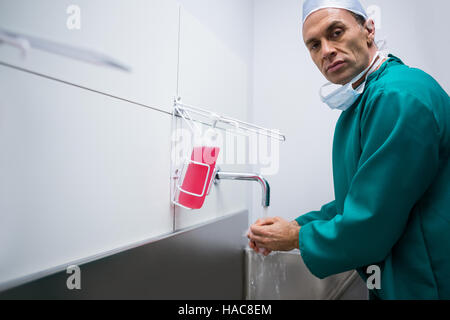 Portrait of surgeon washing hands Stock Photo