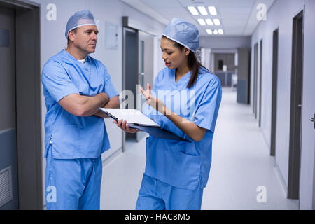 Surgeons discussing over medical reports Stock Photo