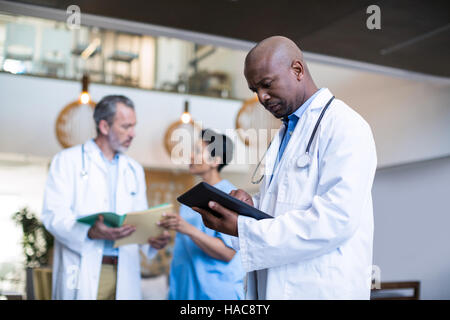 Doctor using digital tablet Stock Photo