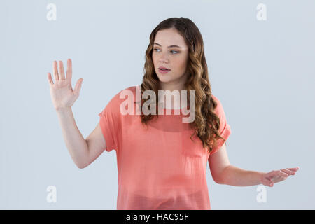 Woman pretending to touch an invisible screen Stock Photo