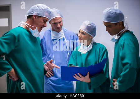 Surgeons having discussion on file in corridor Stock Photo