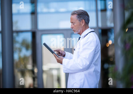 Doctor using digital tablet Stock Photo