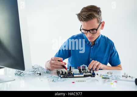 Computer technician repairing motherboard Stock Photo