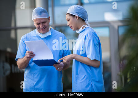 Surgeons discussing over medical reports Stock Photo
