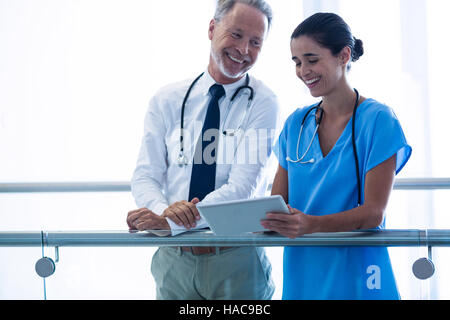 Doctor and colleague discussing over digital tablet Stock Photo
