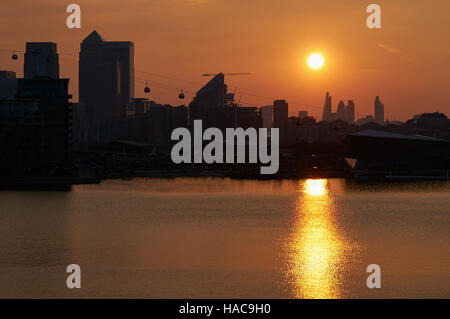 Canary Wharf buildings at sunset, from Royal Victoria Dock, London UK Stock Photo