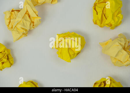 Yellow crumpled paper balls on a white background Stock Photo
