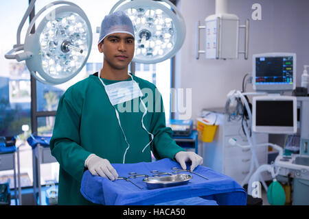 Portrait of surgeon standing in operation room Stock Photo