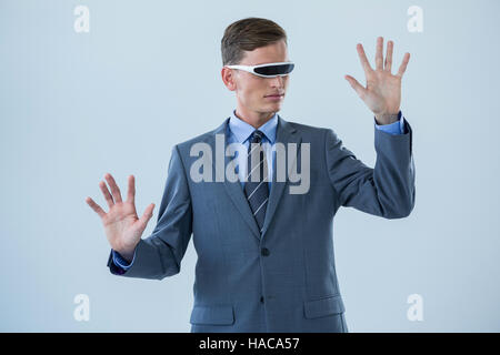 Businessman imagining while using virtual reality glasses Stock Photo