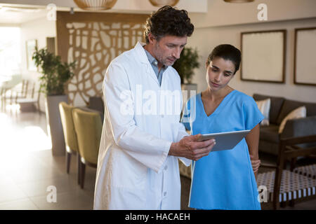 Doctors discussing over digital tablet Stock Photo
