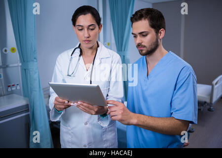 Doctors discussing over digital tablet Stock Photo