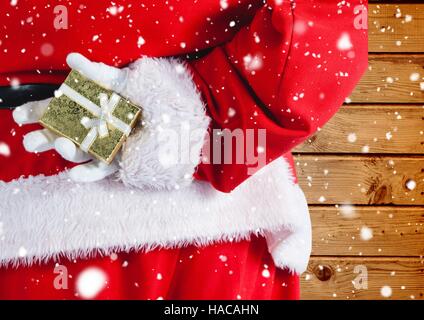 Santa hiding christmas gift behind his back Stock Photo