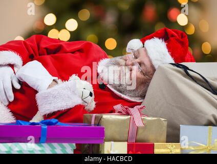 Santa claus sleeping on gift boxes Stock Photo